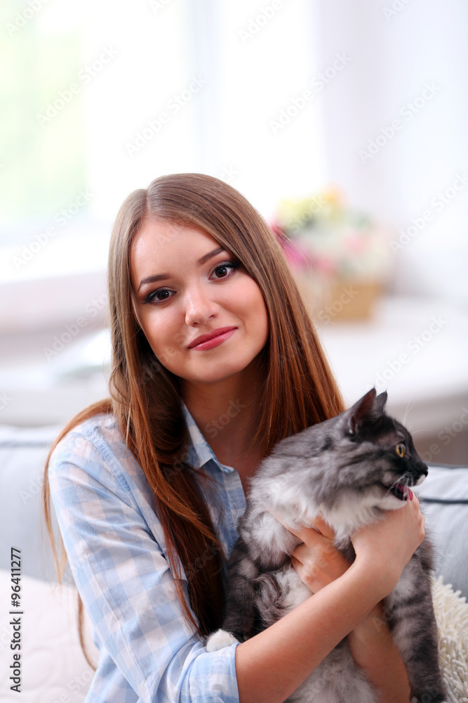 Beautiful young woman with cat at home Beautiful young woman with cat at home