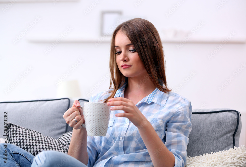 Pretty young woman drinking tea at home Pretty young woman drinking tea at home