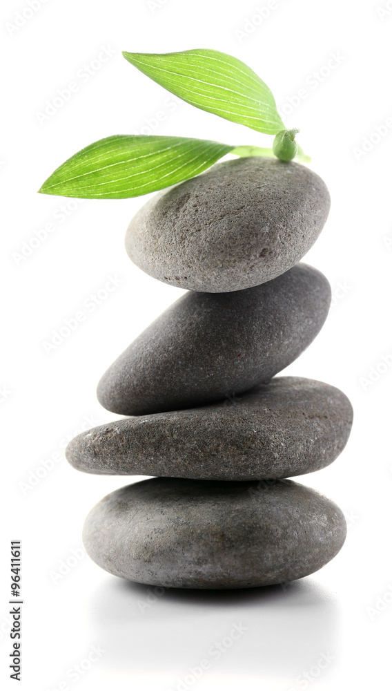 Grey spa stones and green flower, isolated on white Grey spa stones and green flower, isolated on white