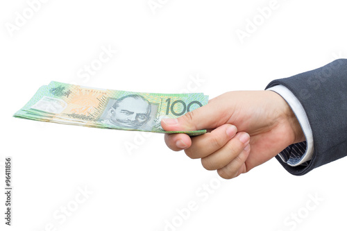 Businessman hand holding Australian dollars (AUD) on isolated background.