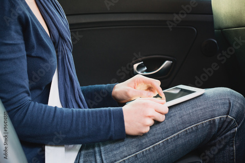 Woman in a Car with a Tablet