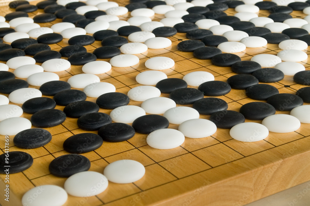 Obraz premium Chinese style Go pieces on wooden board