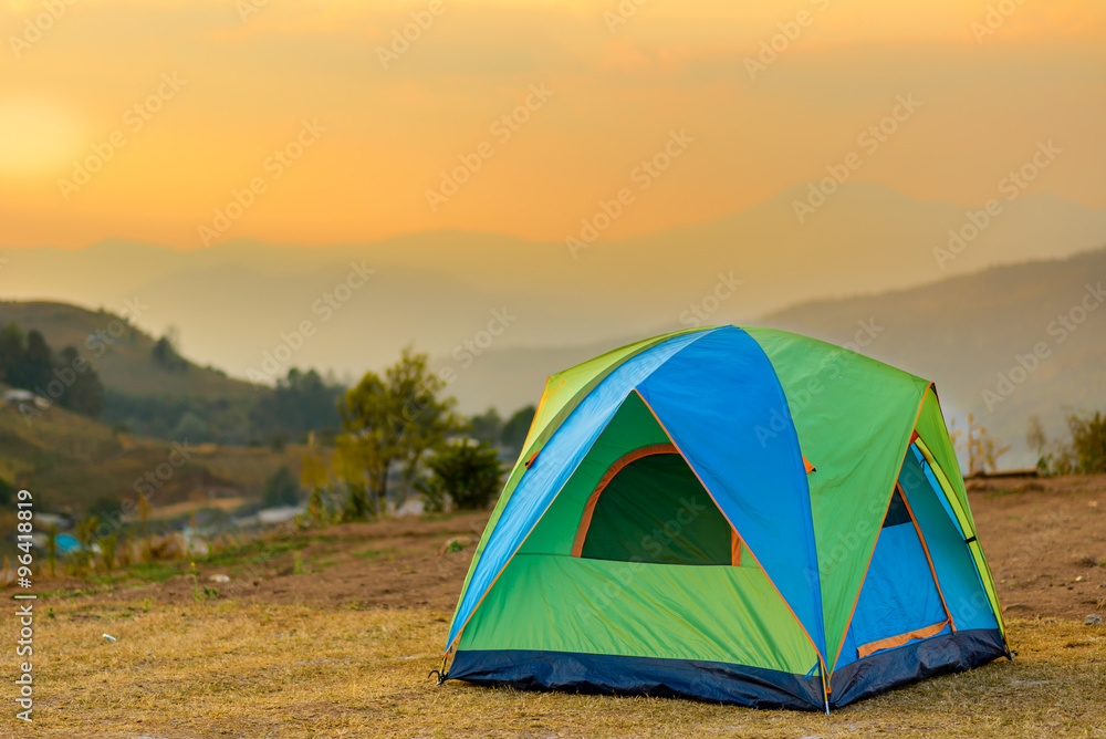tent in the sunset overlooking mountains and a valley
