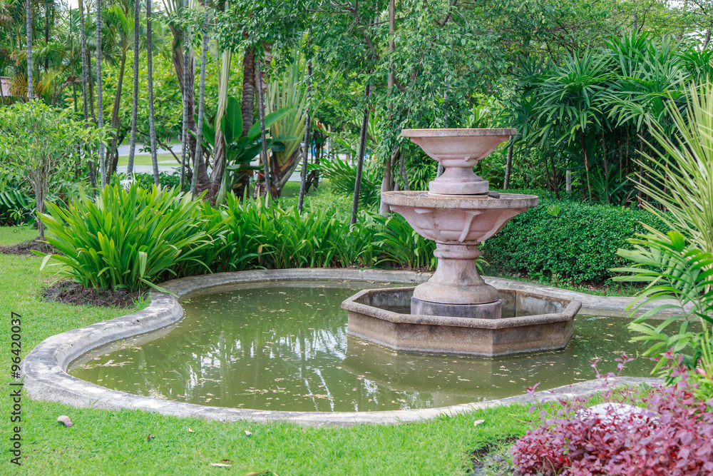 Fountain in green garden, Thailand
