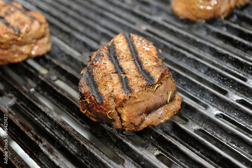 beef steak cooking on an open flame grill