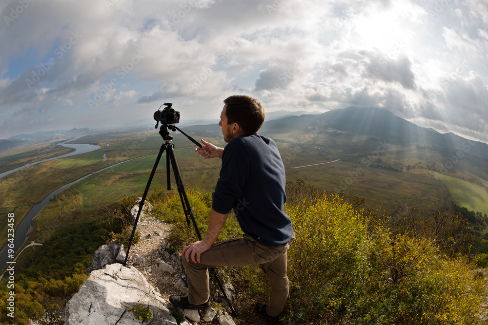 Photographer on top of the mountain. Taken with a fisheye lens