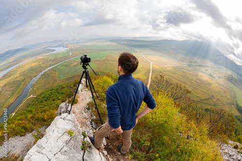 Photographer on top of the mountain takes on the camera. Taken with a fisheye lens