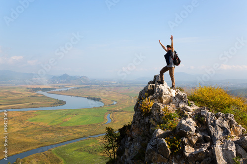 Hiker raises his arms up and screaming with delight