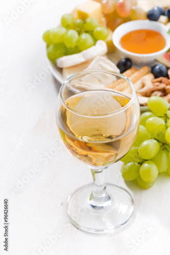 glasses of white wine and snacks , vertical