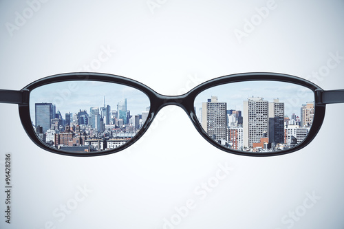 Clear vision concept with eyeglasses with megapolis city at whit