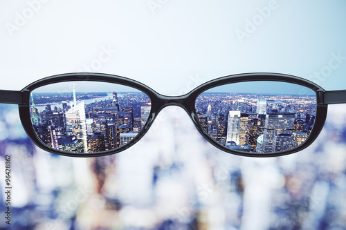 Clear vision concept with eyeglasses and night megapolis city ba