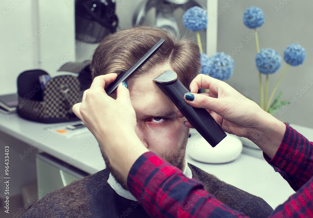 Naklejka premium The young man at the hairdresser salon hairstyle make model