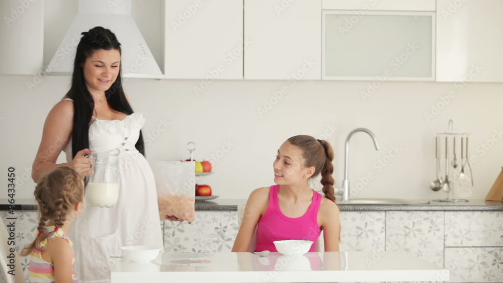 Mother and kids eat breakfast in the kitchen Mother and kids eat breakfast in the kitchen