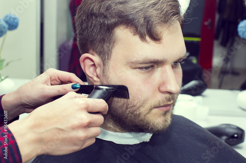 men's haircut in the salon barbershop beard closeup