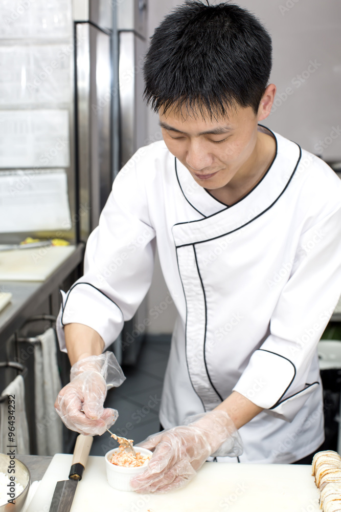 Japanese chef preparing a meal in a restaurant Japanese chef preparing a meal in a restaurant