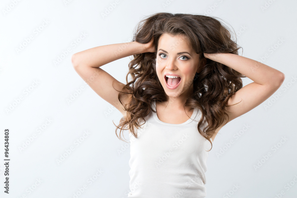 Portrait of beautiful young smiling girl with luxuriant hair curling. Health and Beauty. Portrait of beautiful young smiling girl with luxuriant hair curling. Health and Beauty.