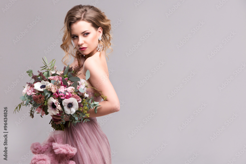 Portrait of a beautiful woman with a bouquet.