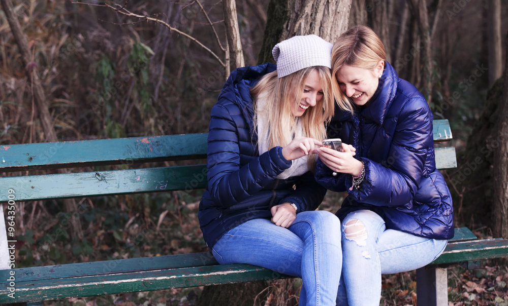 Young woman sitting on bench with her best friend Young woman sitting on bench with her best friend