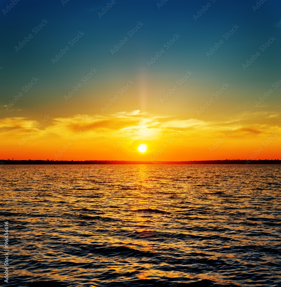 Fototapeta premium orange sunset over dark river