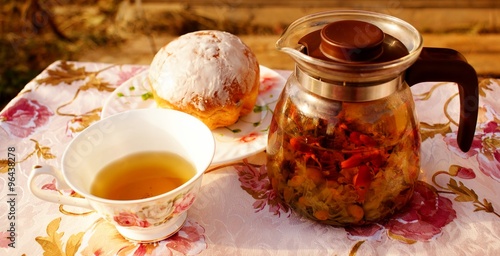 Herbal chamomile tea in a glass teapot