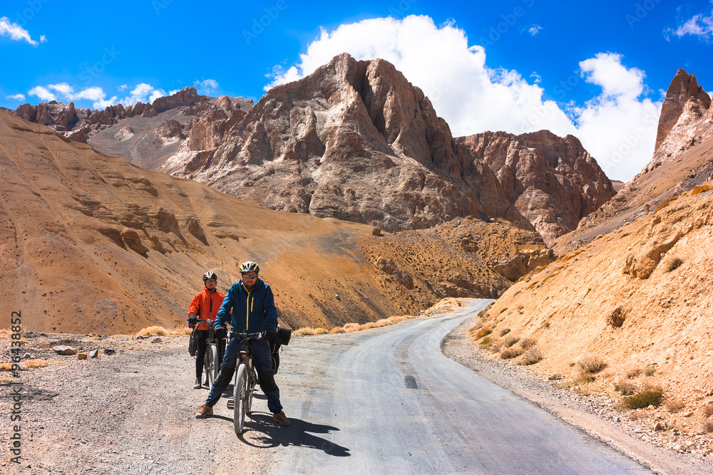 Two cyclist standing on mountains road. Himalayas, Jammu and Kashmir State, North India