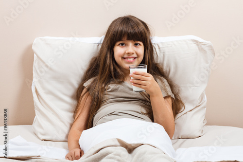 Glass of milk for beautiful little girl