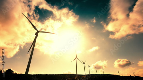 wind mill turbines on mountain timelapse with cloudy sky photo