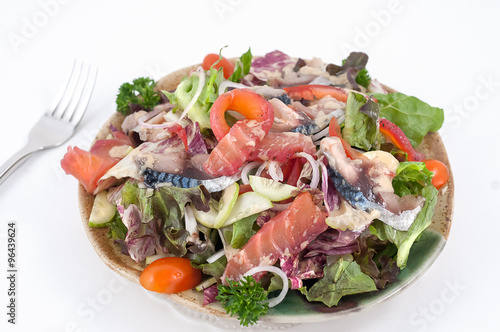 Mixed salad with dressingand greenery isolated on white