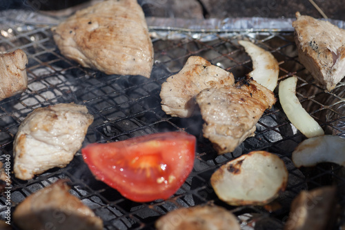  Cooking of a barbecue on a grill