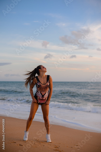 Fototapeta Naklejka Na Ścianę i Meble -  Beautiful young woman in jumpsuit with tiger print on beach