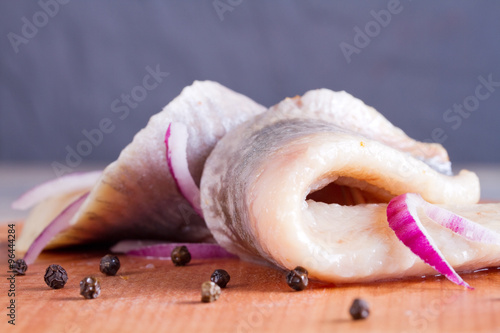 Pieces of herring fillet on a cutting board photo