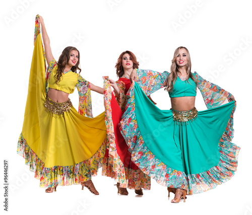 three female dancers posing, isolated on white in full length