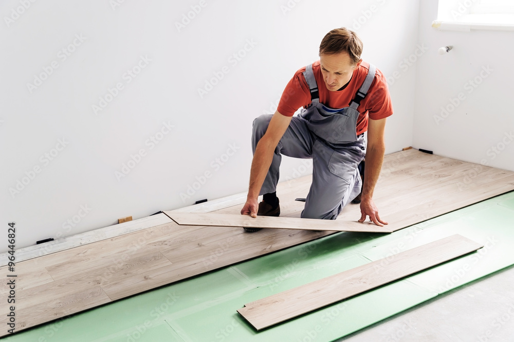 Installing laminate flooring.