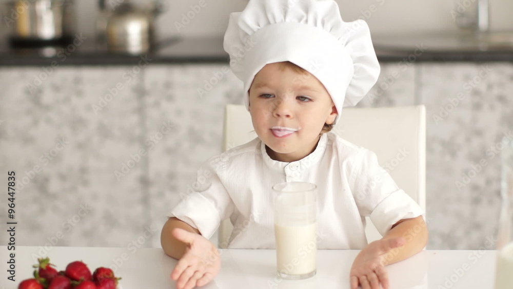 Little boy drinking milk and smiling at the camera Little boy drinking milk and smiling at the camera