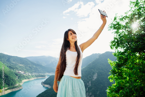 happy girl taking selfie photo on telephone photo