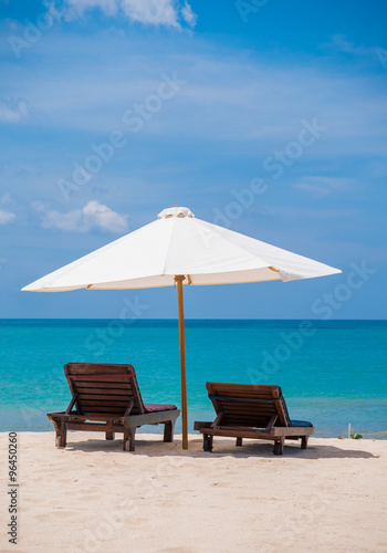 Fototapeta Naklejka Na Ścianę i Meble -  Beach chairs with umbrella and beautiful beach
