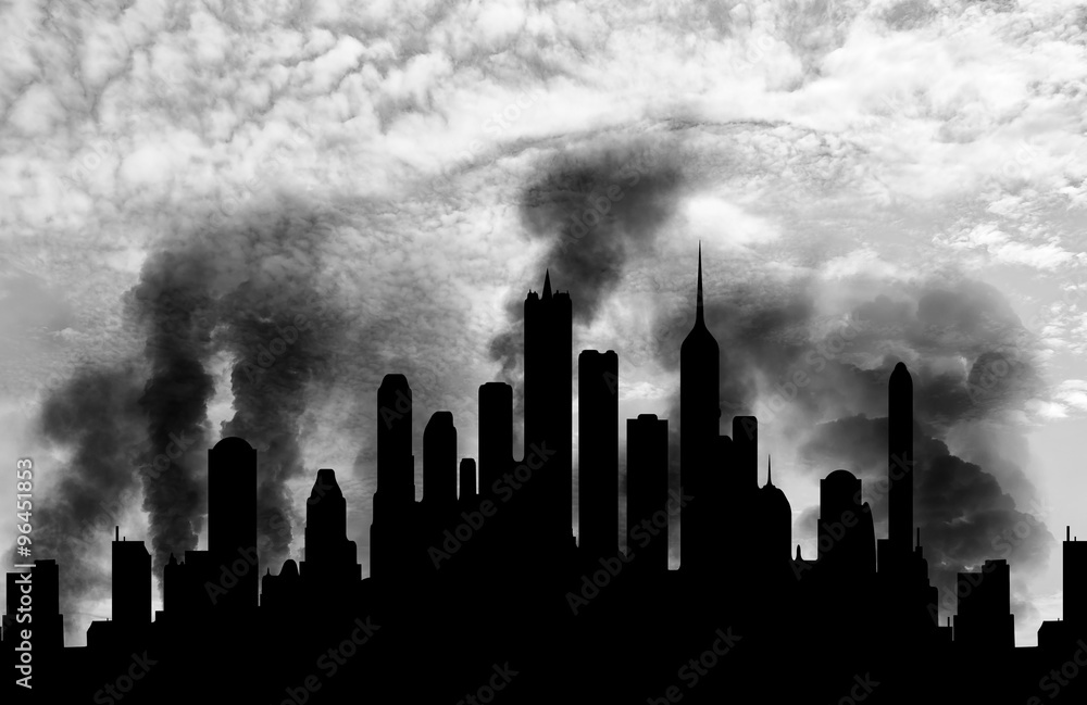 Silhouette of city in smoke against sky