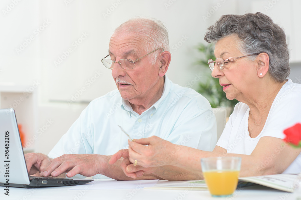 elderly couple in front of the laptop elderly couple in front of the laptop