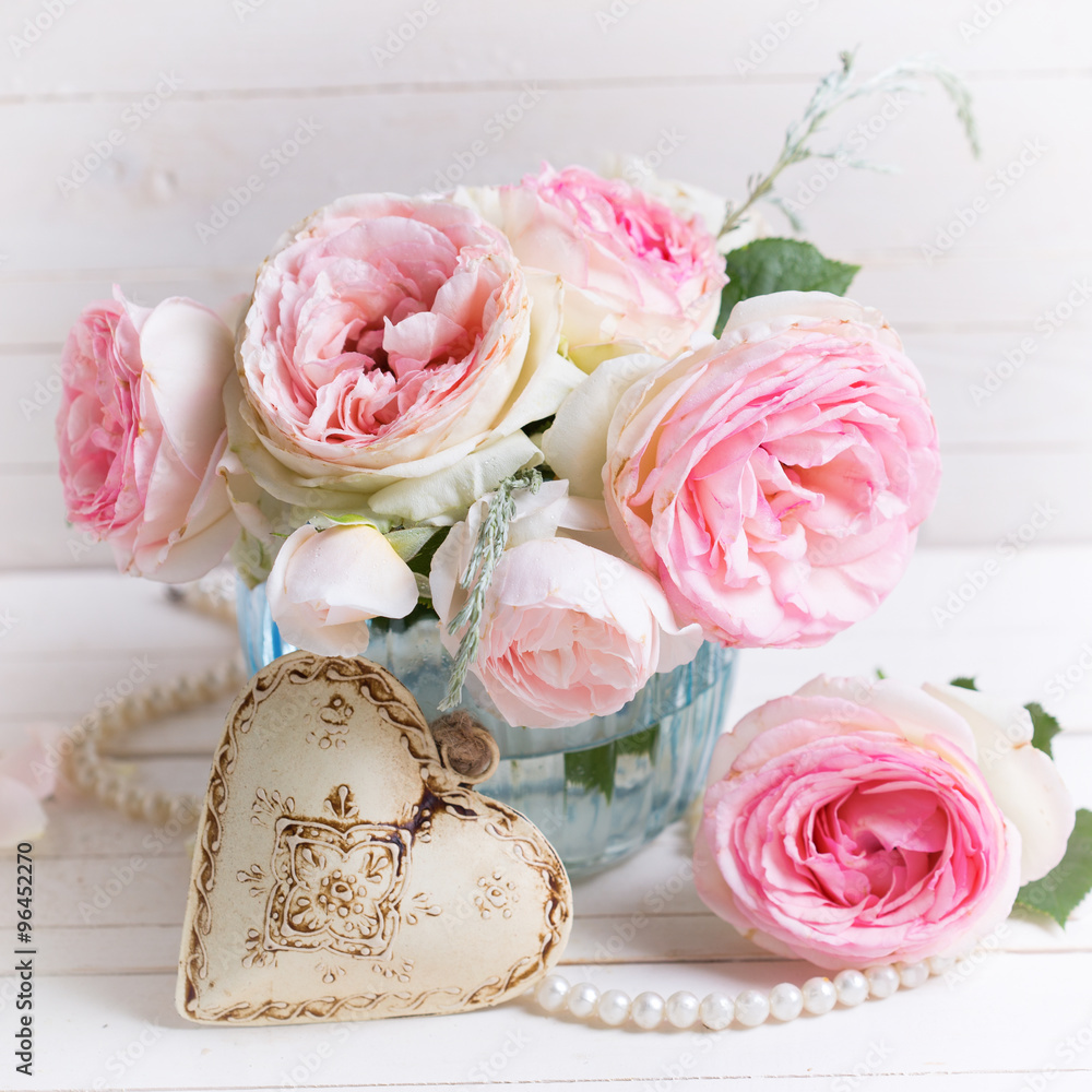 Background with sweet pink roses flowers in blue vase and decor Background with sweet pink roses flowers in blue vase and decor