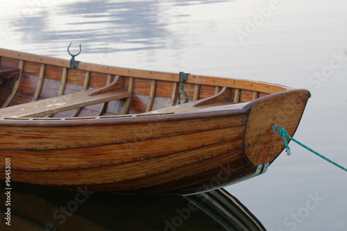 Front of a rowboat in calm water in the harbour