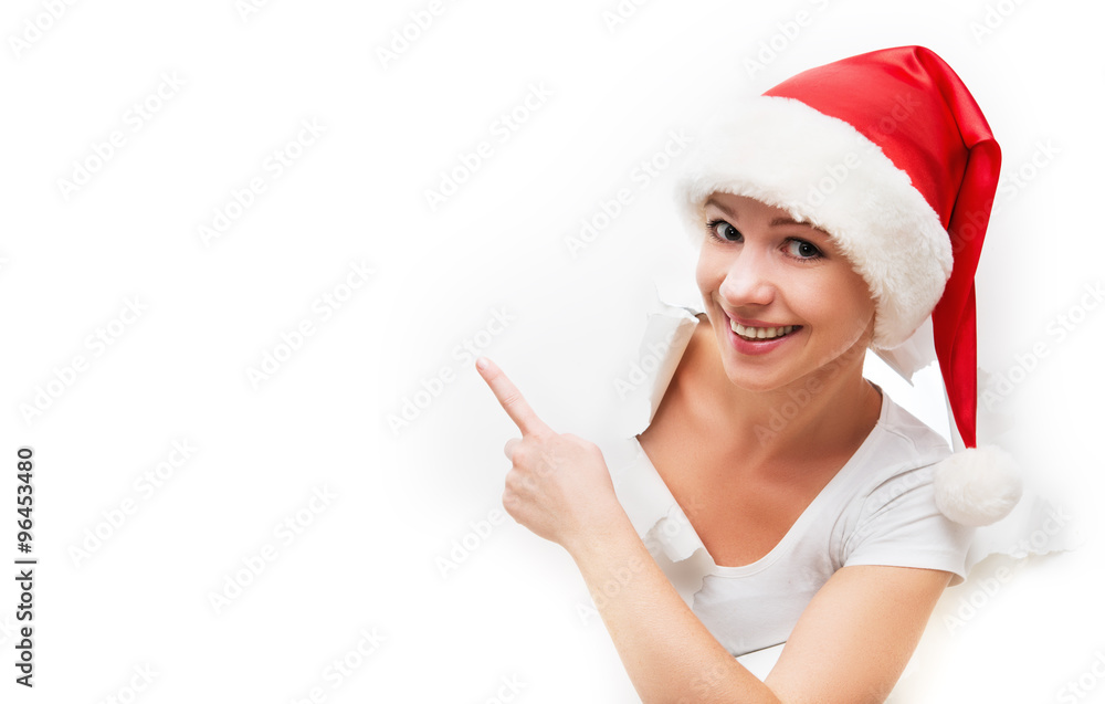 happy woman with christmas hat peeking through a hole torn in w happy woman with christmas hat peeking through a hole torn in w