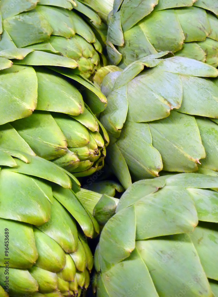 Rows of green artichokes at market Rows of green artichokes at market