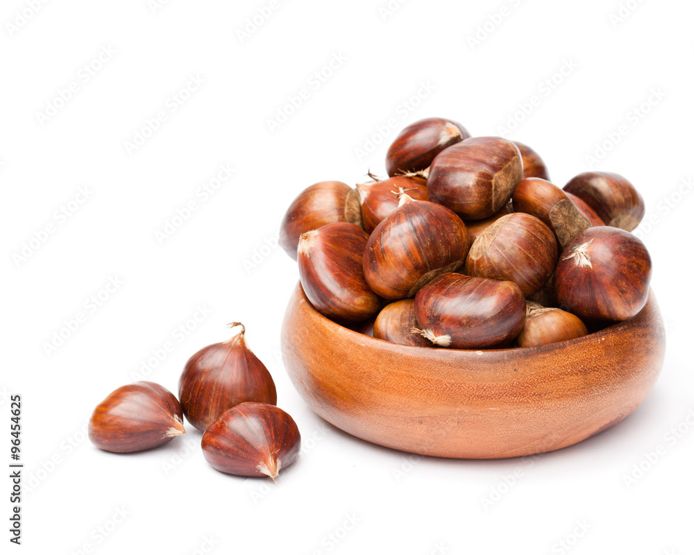 fresh chestnuts in wooden bowl on white background fresh chestnuts in wooden bowl on white background