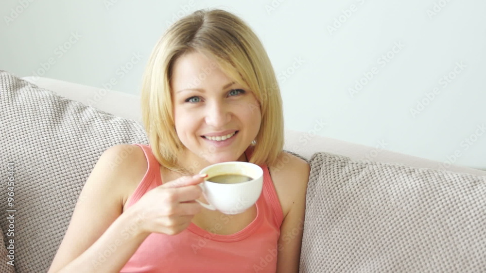 Girl resting on the couch and drinking coffee Girl resting on the couch and drinking coffee