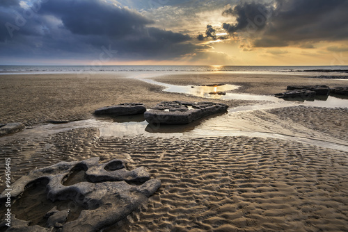 Stunning vibrant sunset landscape over Dunraven Bay in Wales