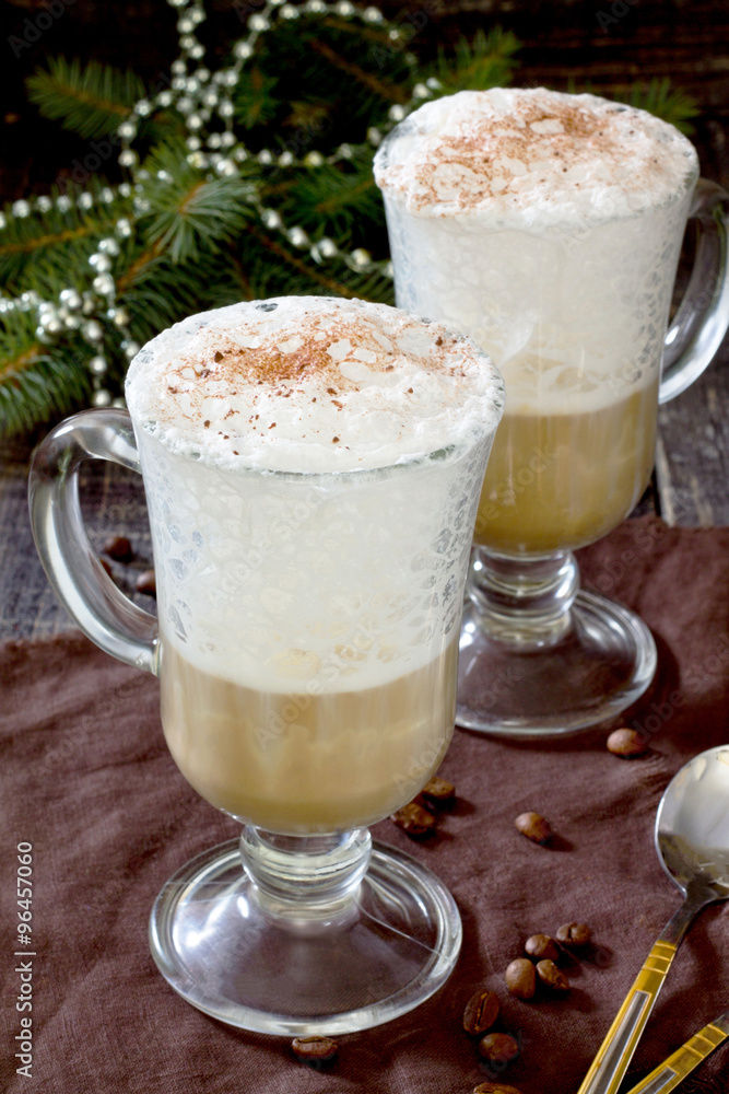 Cappuccino with a decorated Christmas tree on a wooden table Cappuccino with a decorated Christmas tree on a wooden table