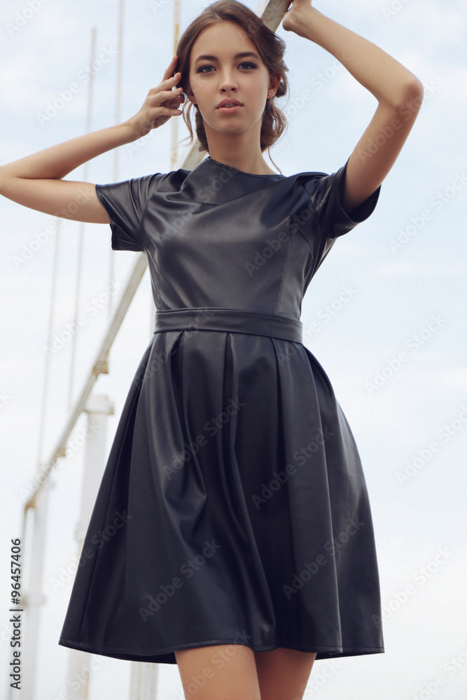 young girl with dark hair in elegant dress,posing beside the sea young girl with dark hair in elegant dress,posing beside the sea