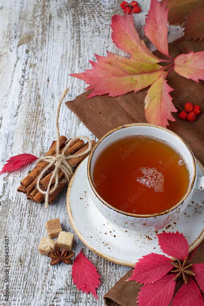 Cup of autumn tea on light wooden background Cup of autumn tea on light wooden background