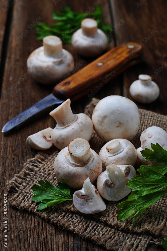 Raw champignon mushroom on wooden background Raw champignon mushroom on wooden background