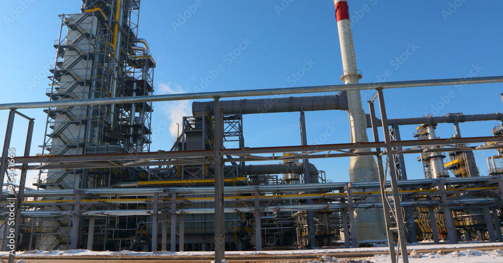 Modern oil refinery factory (petroleum refinery) against a blue sky